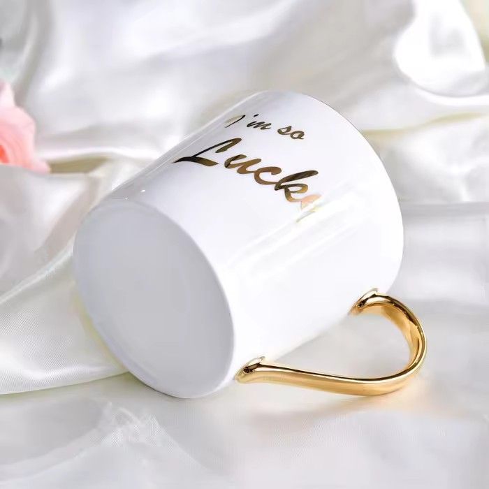 Wholesale gold handle ceramic mug white bone china christmas mug with logo