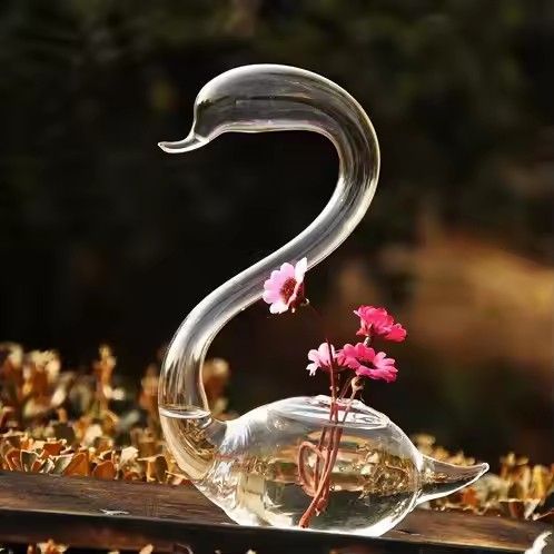 Swan shaped mouth blown glass vase for flower arrangements